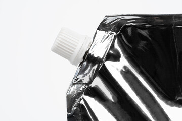 Blank spout pouch with cap or doy pack. Front view of blank glossy white doypack with cap or stand-up pouch isolated on white background.