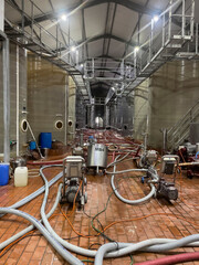Robertson, Western Cape, South Africa. 2023.  Fermentation tanks in a wine cellar being cleaned...