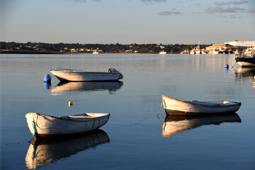 Three small boat on the shore at sunset