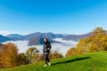 Woman Joy Mountain Range on the Border to Italy on Lake Lugano with Cloudscape and Sunlight on a...