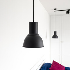 Modern and designer Scandinavian bedroom. Black lamp on a white background