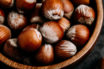 Hazelnuts. Whole Hazelnuts in wooden bowl on dark background