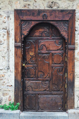 Close-up of a  brown wooden door in an old stone mansion house