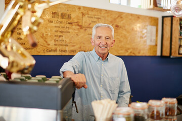 Owning a cafe has always been my dream. Shot of a senior man working in a coffee shop.