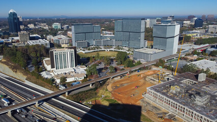 Fototapeta premium Large construction sites of high-rise office buildings and highway along Interstate 285 (the Perimeter) and Ashford Dunwoody road in midtown Atlanta, Georgia, USA