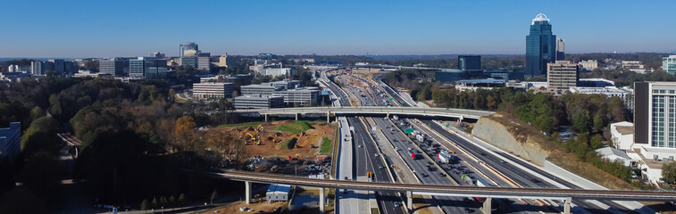 Panorama aerial Skytrain railway, elevated bypass, busy traffic on Highway I-285 (the Perimeter),...