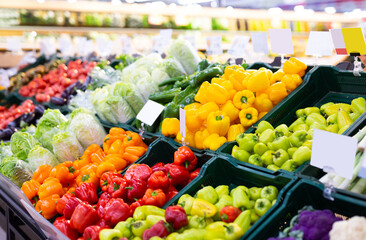 peppers of different colors on the counter of the supermarket