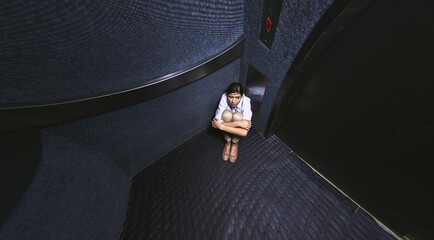 Nothing to do but wait. Distorted shot of a young woman trapped in an elevator. - obrazy, fototapety, plakaty
