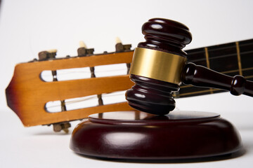 Music copyright law concept. Guitar and judge gavel