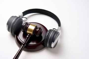 Fototapeta na wymiar Music copyright law concept. Headphones and judge gavel