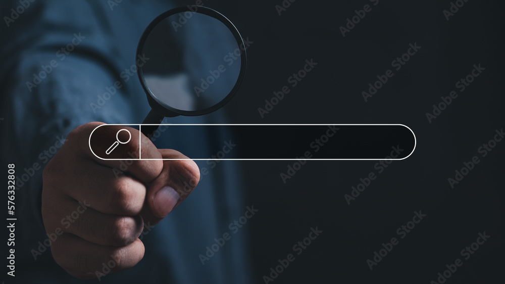 Wall mural hand holding magnifying glass. searching for information. using search console with your website. da