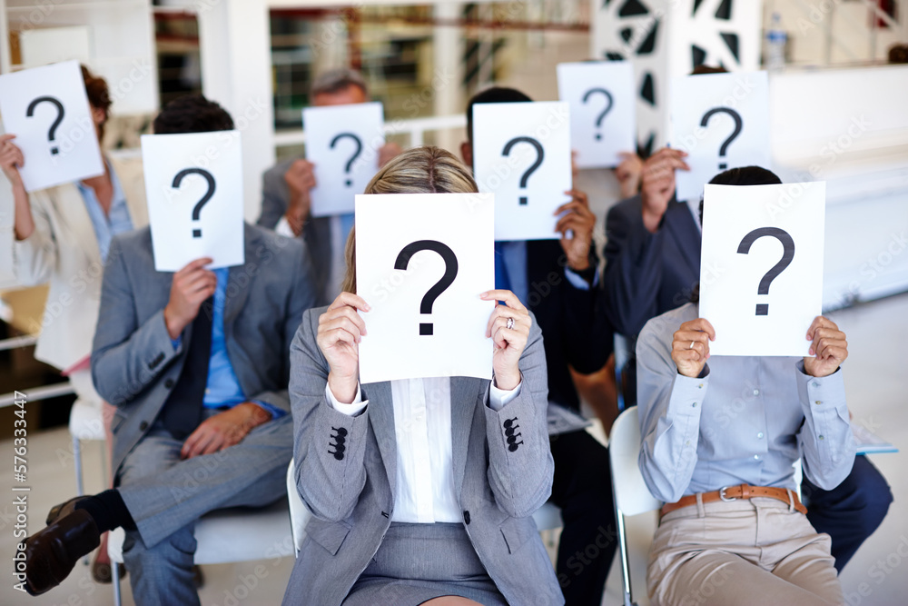 Aufkleber shed a little light on this. shot of a group of businesspeople holding up signs with question marks 