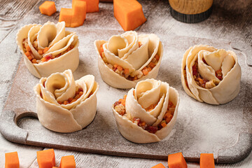 Semi-finished rose shaped manti dumplings with beef and pumpkin