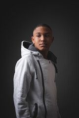 Portrait of very serious African-American teenager on a black background