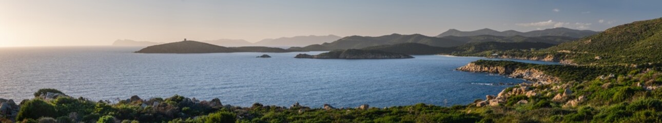 Fototapeta na wymiar Panoramic view of Mediterranean Sea shore, Capo Malfatano, Island Isola di Tueredda, Tuelada, South Sardinia. Seascape at sunset, Italy.