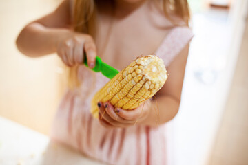 
child cutting corn