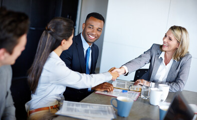 It was nice meeting you. Shot of professional coworkers shaking hands during a meeting in the...