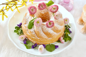 Easter ring cake with fresh daisy and violets decoration