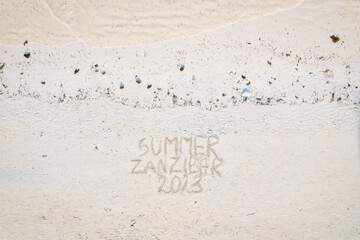 Etched into the sand of Zanzibar's vacation beach is a captivating inscription.