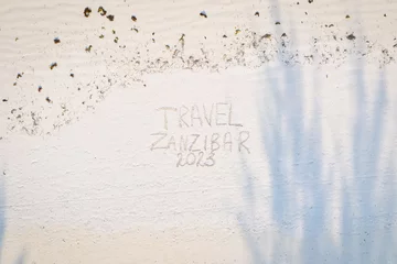 Fotobehang Etched into the sand of Zanzibar's vacation beach is a captivating inscription. © Sebastian