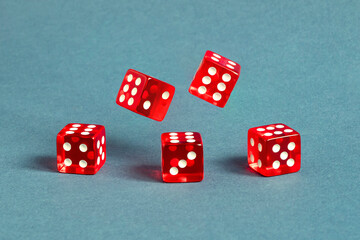 Random number generator. Five red dice with numerical values lie in a chaotic order.
