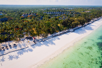 This stunning toned aerial view captures the beauty of Kiwengwa beach in Zanzibar, Tanzania. The luxurious resort and the turquoise ocean water create a picture-perfect scene.