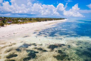 The stunning beauty of Kiwengwa beach in Zanzibar is on full display in this mesmerizing aerial drone footage, showcasing its palm tree-lined shore and turquoise waters