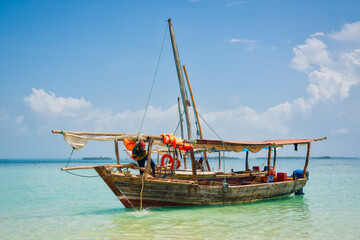 Board a traditional wooden dhow boat and discover the natural wonders of Zanzibar's Blue Safari, from coral reefs to deserted islands. © Sebastian