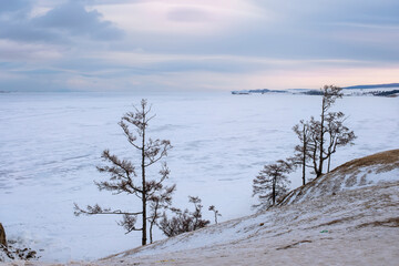 Coast of Olkhon Island in February at sunset. Winter Baikal, Russia