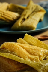 Pamonha typical Brazilian food made of cooked corn with corn background