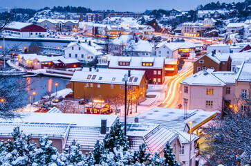 Small town with glowing houses in winter