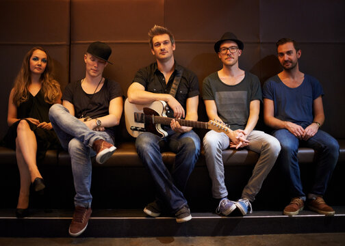 A band posing for a photo before a big show. This concert was created for the sole purpose of this photo shoot, featuring 300 models and 3 live bands. All people in this shoot are model released. - Powered by Adobe
