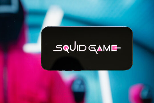 Madrid, Spain - February 23, 2023: Squid Game logo on mobile phone. Squid Game is a popular South Korean survival drama television series available on Netflix.
