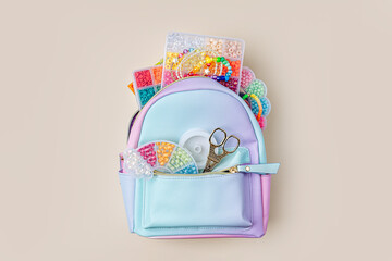 Fashion backpack with beads and boxes for children's needlework and crafts. Kids stuff and ...