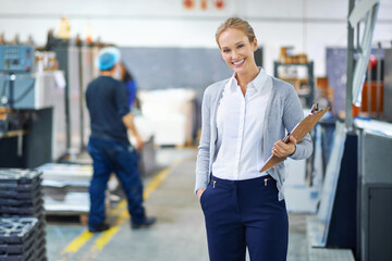 Focused on raising the bar each step of the way. A young manager looking confident while on the factory floor.