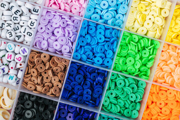 Box with multi-colored beads for children's needlework and crafts.  Handmade and DIY art activity for kids. Motor skills and creativity, hobby