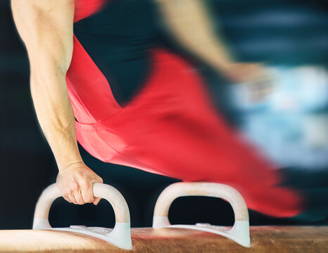 Horse, gymnastics and motion blur with the hands of a man training for an olympics event or sports. Exercise, balance and speed with a male athlete or gymnast in a studio or gym for competitive sport