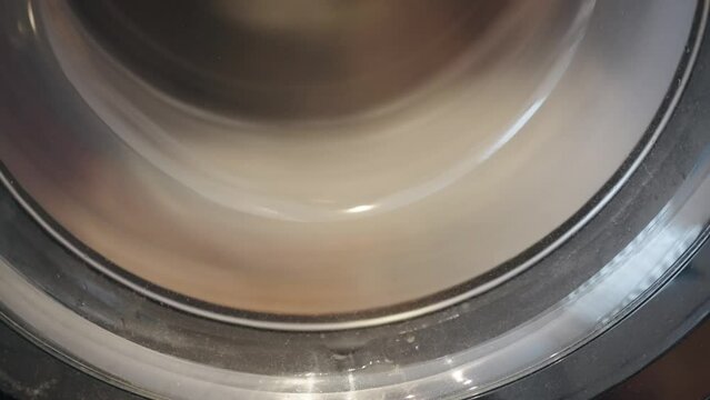 Modern Washing Machine in process of wahing a dirty clothes, slow motion