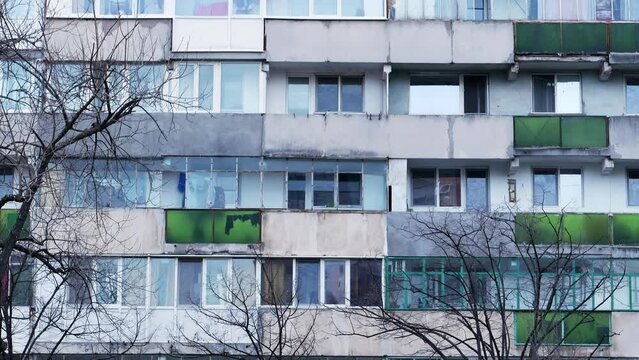 Worn out apartment building from the communist era against blue sky in Bucharest Romania. Ugly traditional communist housing ensemble