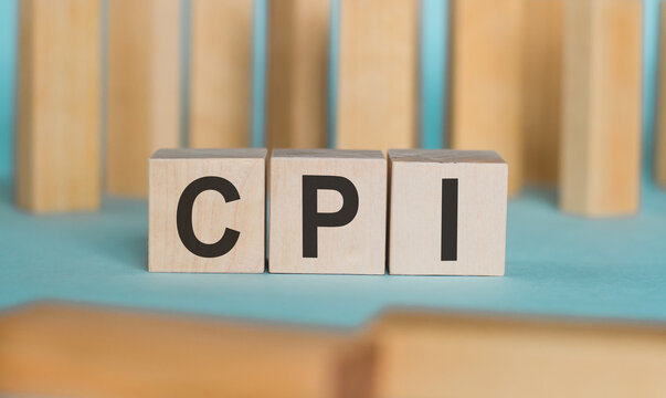 Abbrevation CPI on wood cube with on the table, economic data concept.
