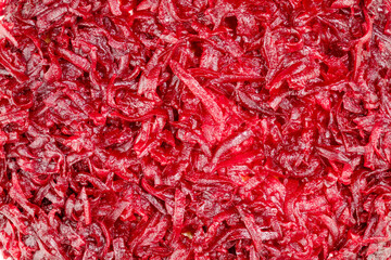 Fototapeta premium Vegetable background with close up of boiled grated beets. Vegan and vegetarian background