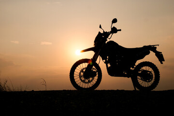 Obraz na płótnie Canvas silhouette of a bike. silhouette of a motorcycle. motorcycle on sunset. Silhouette Motocross Motorcycle