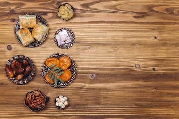Ramadan kareem Iftar party table with assorted festive traditional Arab dishes, sweets, dates. Eid al-Fitr mubarak evening grand meal, top view.