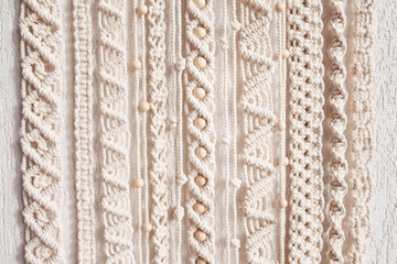 Handmade macrame pattern. Macrame braiding and cotton threads.  Female hobby.  ECO friendly modern knitting DIY natural decoration concept in the interior. 100% cotton home decoration. - obrazy, fototapety, plakaty