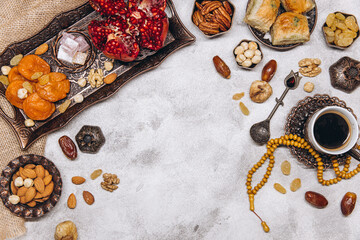 Banner with traditional Arabic dishes and food sets on it, Koran and rosary. Ramadan table top view