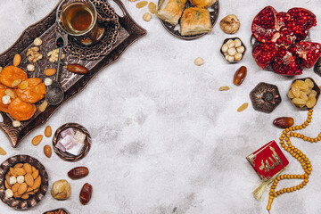 Banner with traditional Arabic dishes and food sets on it, Koran and rosary. Ramadan table top view