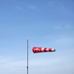 Windsock and blue sky at a paraglider starting point