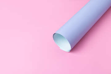 Blue and pink paper background. Space for text. Concept of spring. Twisted blue background