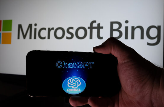ChatGpt Logo Seen On Smartphone Hold in A Hand And Pc Display With MICROSOFT Bing logo On The Background. Istanbul, TURKEY- February 28, 2023.