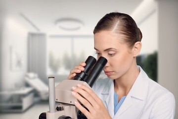 Fototapeta premium Medical research laboratory, young scientist looking in microscope